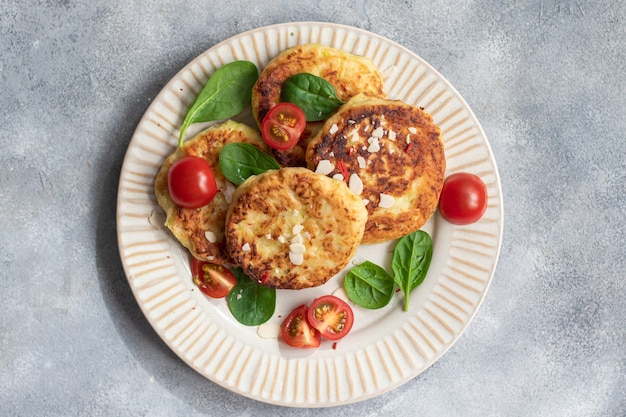 Vegan food. zucchini pancakes with tomatoes and spinach