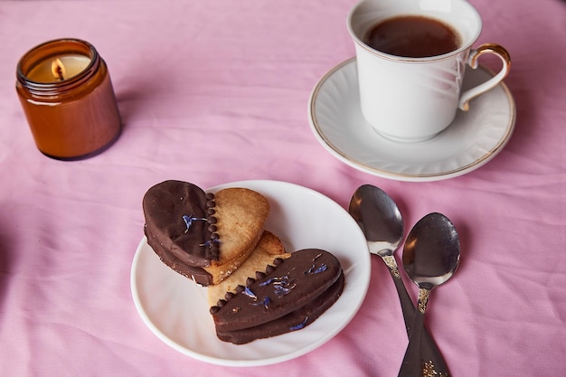 Vegan heart shaped cookies aesthetics pink Valentines day flat lay coffee and candle