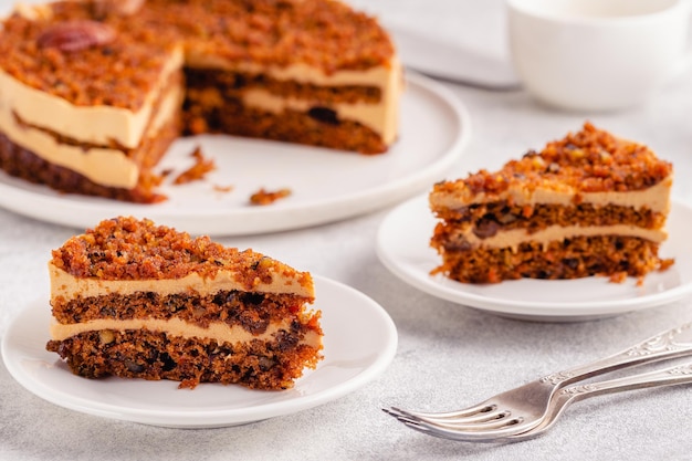 Vegan homemade carrot cake with pecans,  on a light background.