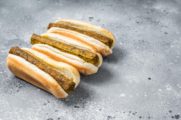 Vegan hot dog with meatless Vegetarian sausage. Gray background. Top view. Copy space.