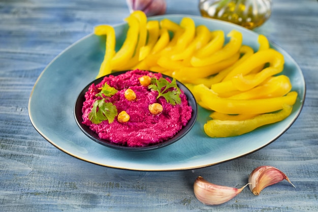 Vegan hummus dip with healthy vegetables