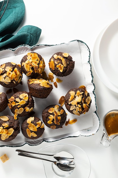 Vegan muffins with banana and almond chips with espresso on a tray gluten free and refined sugar free paleo