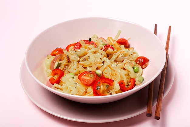 Vegan noodles with peas, peppers, onion and zucchini