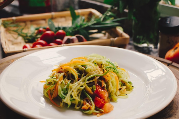 Vegan pasta a sliced vegetable salad close up