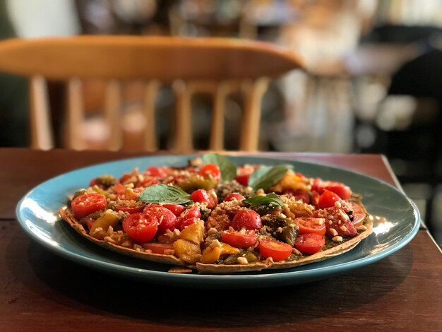 Vegan pizza close up on table in vegan restaurant. Food business background