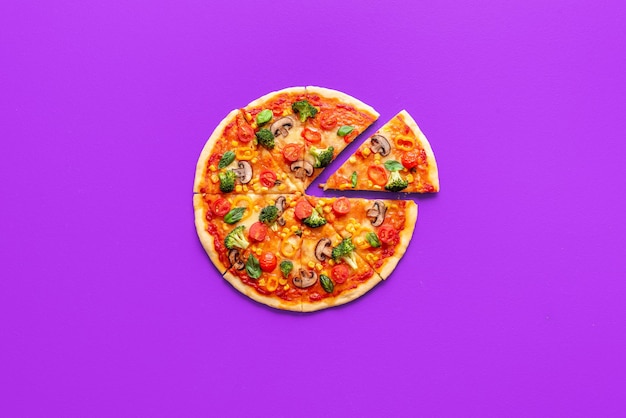 Vegan pizza top view isolated on a purple background