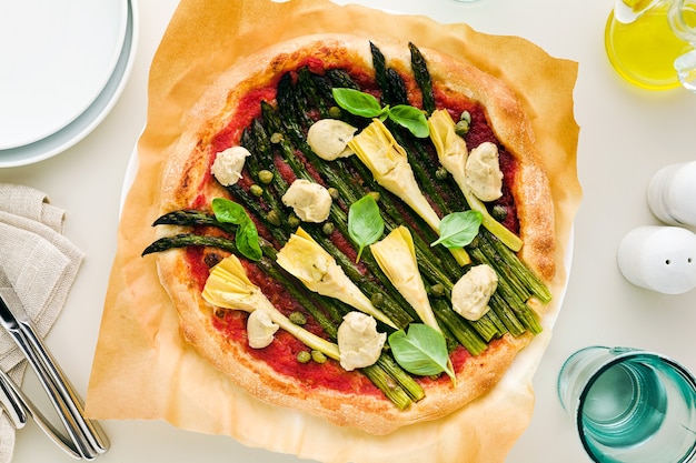 Vegan pizza with asparagus and artichokes