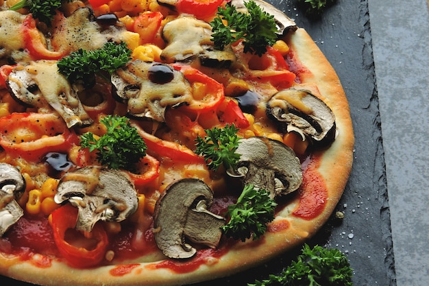 Vegan pizza with mushrooms, vegetables and herbs. Keto diet. Pegan diet.