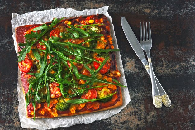 Vegan pizza with vegetables and sauce.