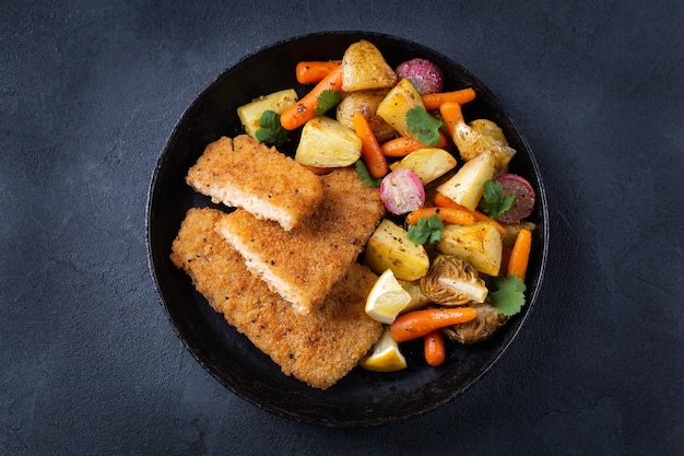 Vegan plant based fish with crispy batter and roasted vegetables