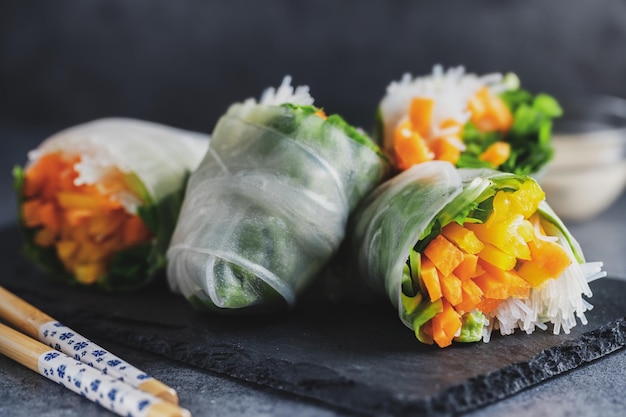 Vegan rice paper rolls with vegetables and sesam served on plate ready to eat