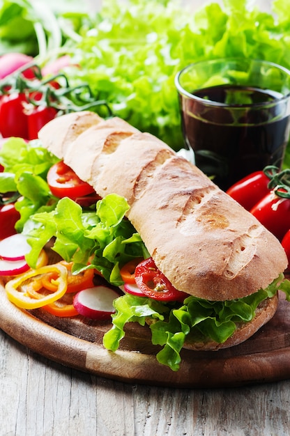 Vegan sandwich with salad, tomato and radish