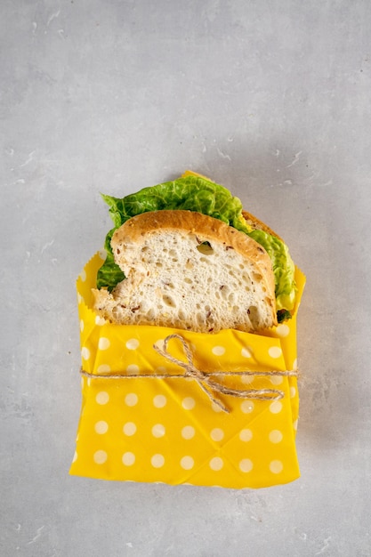 Vegan sandwich with sourdough nongluten bread wrapped in reusable beeswax cloth zero waste concept