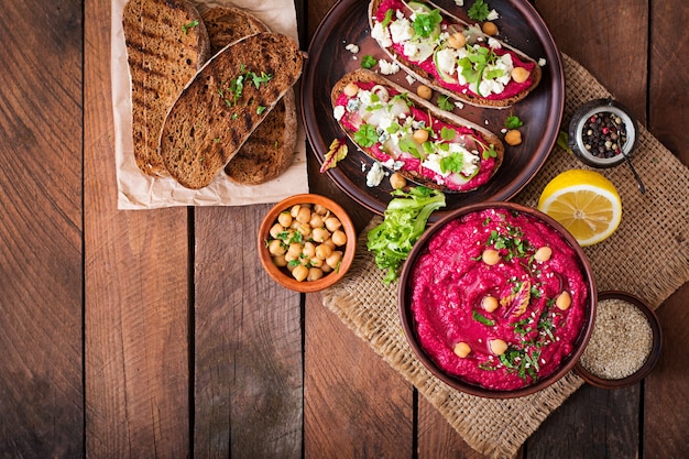 Vegan sandwiches with beetroot hummus, cucumber and blue cheese.