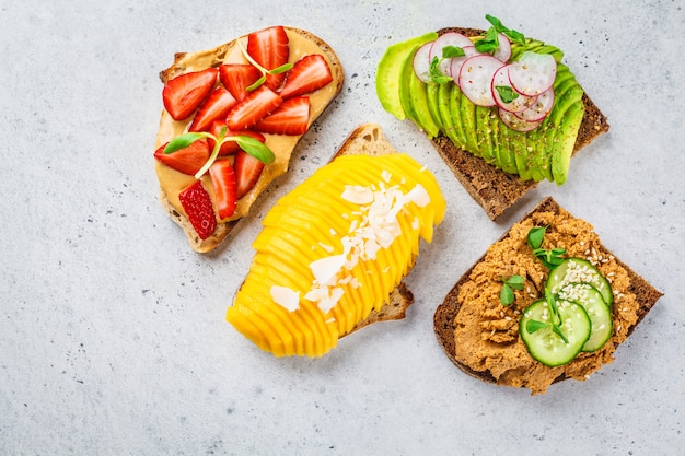 Vegan sandwiches with mango, strawberry, tofu pate, avocado 