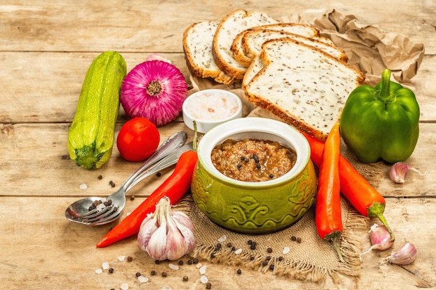 Vegan stew with a set of fresh vegetables Chopped cooked ingredients bread cutlery and spices