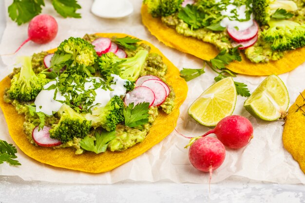 Vegan tacos (pizza, pita) with radish, broccoli and guacamole, top view. healthy vegan food concept