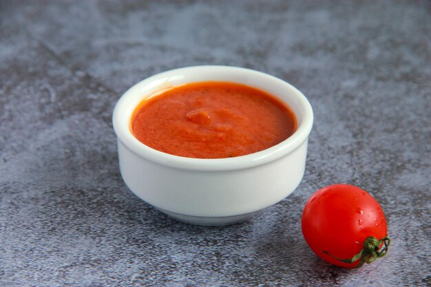 Vegan tomato sauce in the bowl - ingredient for cooking