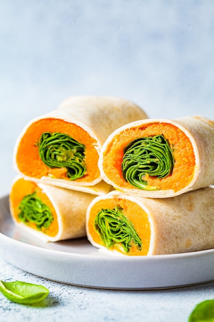 Vegan tortilla wraps with sweet potato and spinach. Healthy vegetarian food concept.