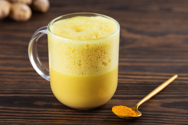 Vegan whipped turmeric golden latte from almond milk ginger turmeric and cinnamon in mug