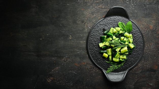 Veganistensalade met komkommer en dille op een zwarte plaat Rustieke stijl Bovenaanzicht Vrije ruimte voor uw tekst