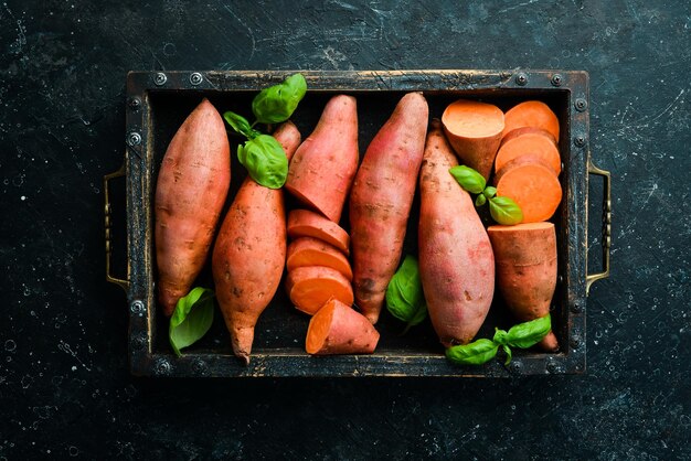 Veganistisch eten Zoete aardappelen in een houten kist Bovenaanzicht Vrije ruimte voor uw tekst