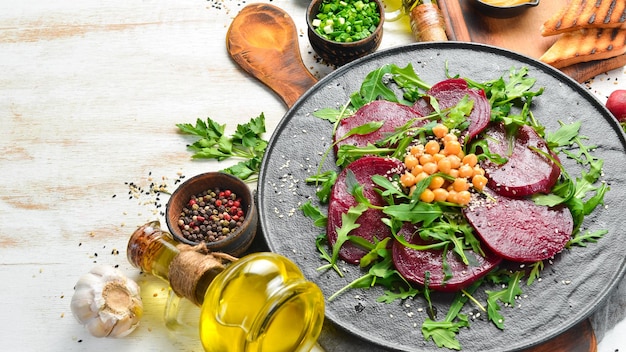 Veganistische salade bieten rucola en kikkererwten op een zwarte stenen plaat gezonde voeding bovenaanzicht vrije ruimte voor tekst