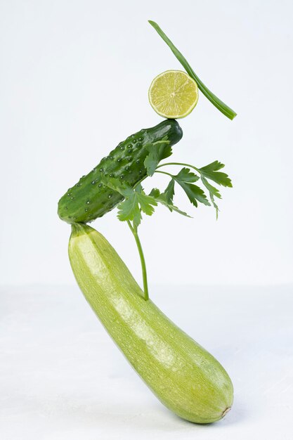 Vegetable art composition - abstract balancing construction of fresh green vegetables. Avant garde, modern visual art, fashion, minimal design, healthy food concept.