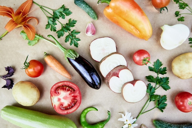 Photo vegetable backround beet basil eggplant parsley bell pepper hot pepper potatoes cucumber carrots and flowers italian vegetable recipe veganism concept foodtop view copy space high quality photo