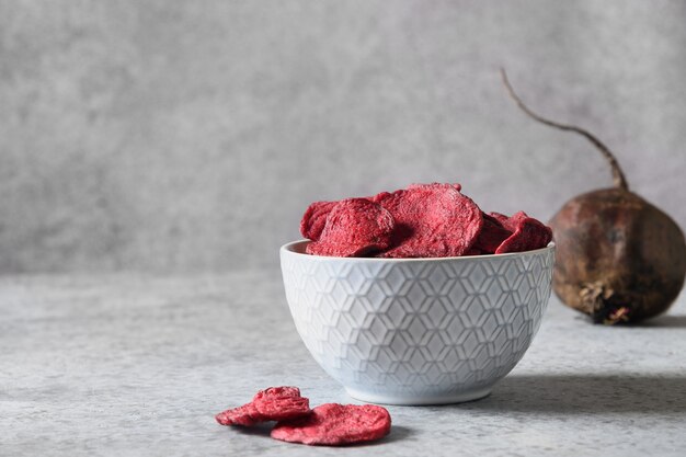 Vegetable beetroot vegan chips in gray bowl