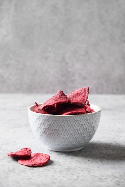 Vegetable beetroot vegan chips in gray bowl