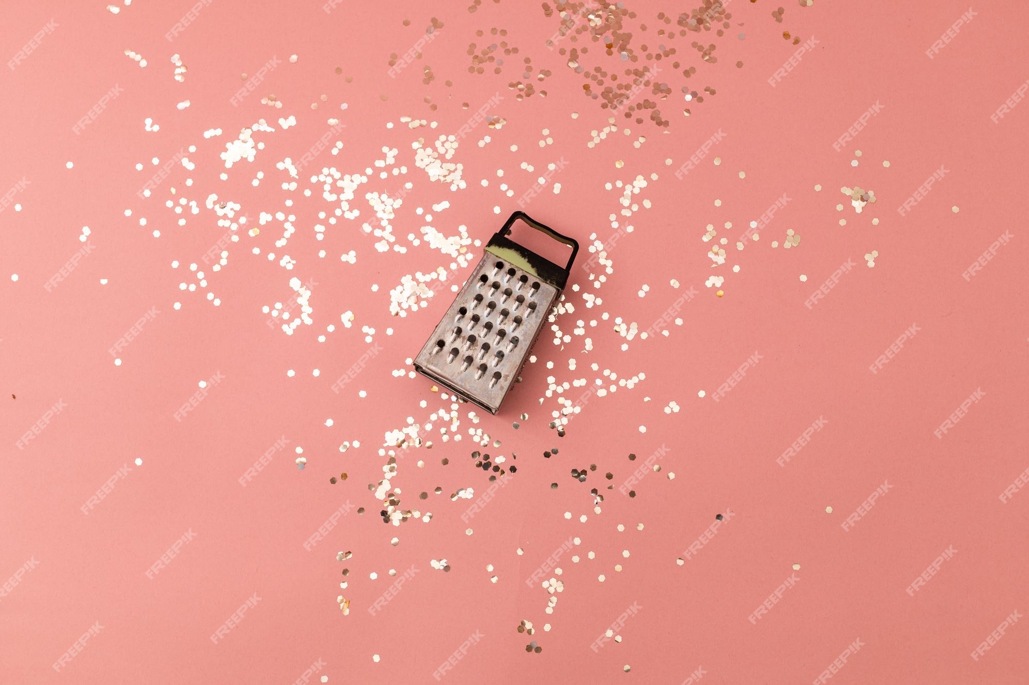 Premium Photo  Vegetable and cheese grater on a pink festive background