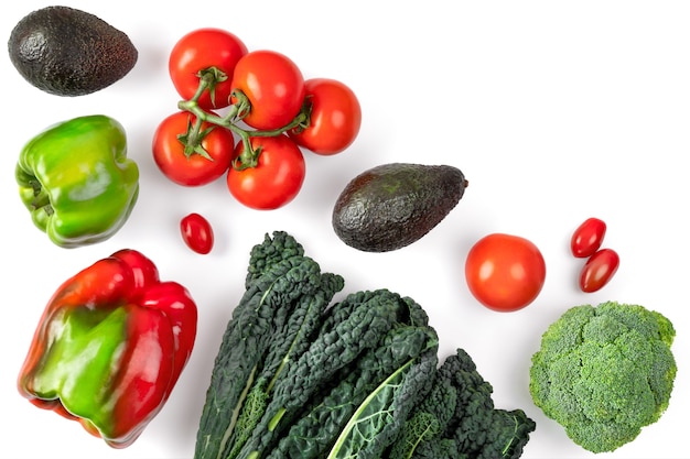 Vegetable composition on white space. Black curly kale, tomatoes,