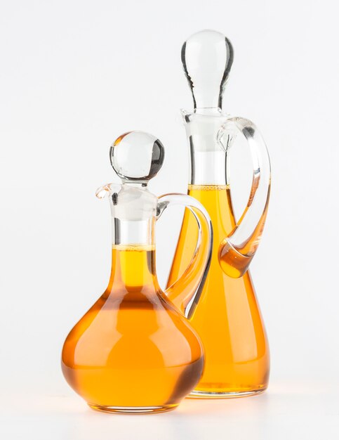 Vegetable oil glass bottle on white surface