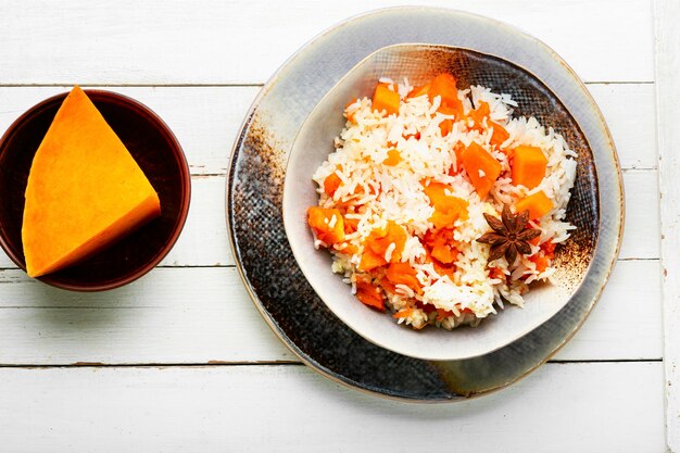 Vegetable pilaf on a plate, rice with pumpkin. Vegetarian food