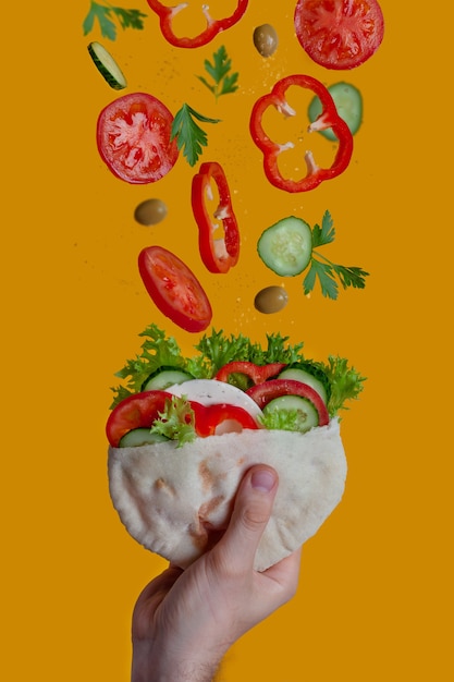 Vegetable pita in a man's hand