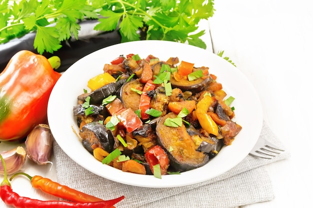 vegetable ragout with eggplant, tomato, sweet pepper, onion, carrot in plate  