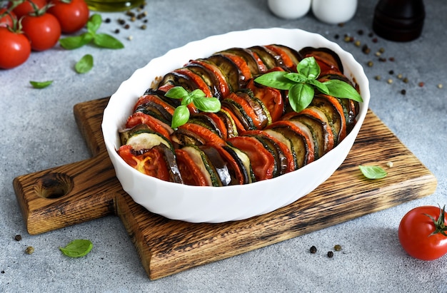 Vegetable ratatouille on the kitchen table. Baked vegetables.