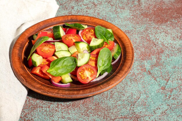 Vegetable salad on a concrete background, top view