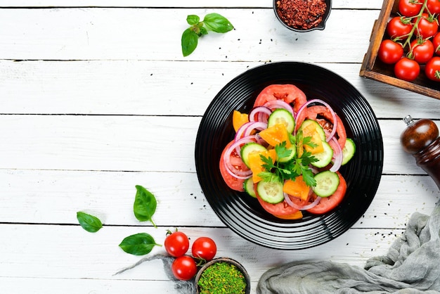 Vegetable salad Tomatoes cucumber onions parsley Top view Free space for your text