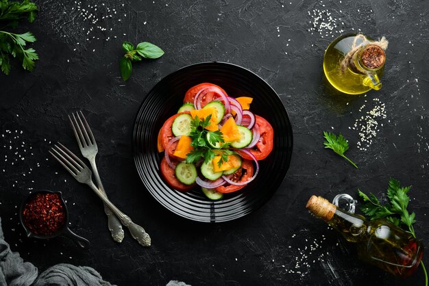 Vegetable salad. Tomatoes, cucumber, onions, parsley. Top view. Free space for your text.