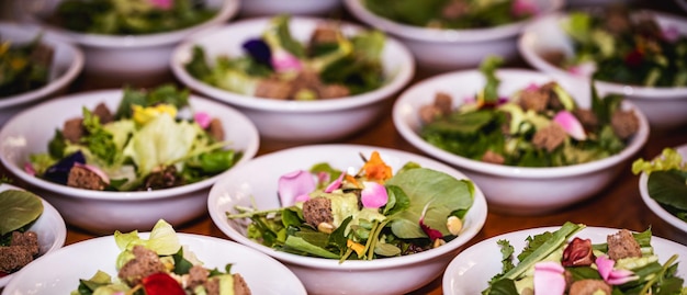 Vegetable salad vegetables and flowers multiple salad bowls with arugula flower petals vegan toast