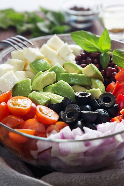 Vegetable salad with avocado, olives and tomatoes