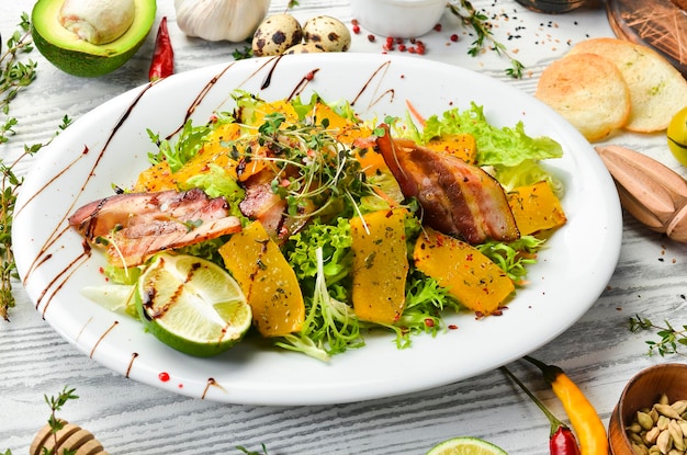 Vegetable salad with bacon and pumpkin Healthy food Top view Rustic style