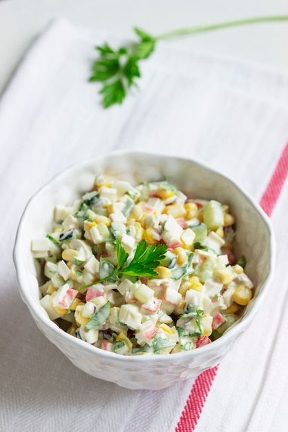 Vegetable salad with crab sticks, dressed with mayonnaise. Selective focus.