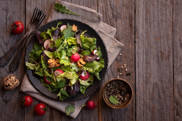 Vegetable salad with green leaves seeds and radish