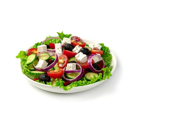 Vegetable salad with olives and feta cheese on white