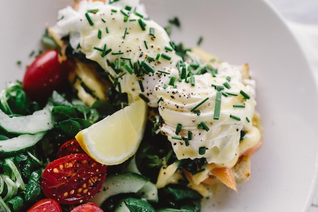 Photo vegetable salad with poached egg, spinach, chorizo. summer recipe, keto diet. selective focus.