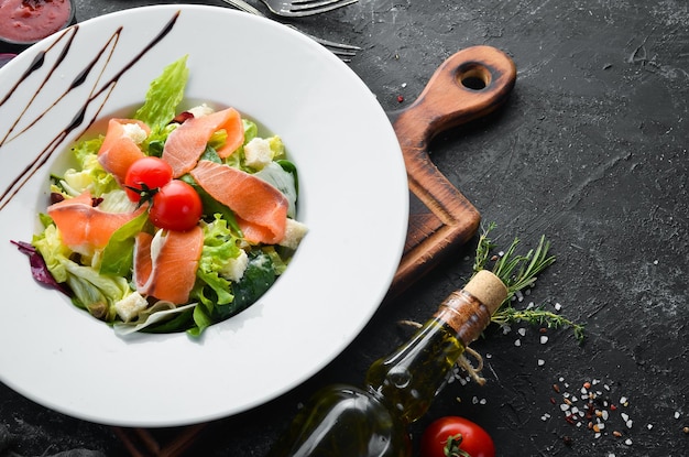 Vegetable salad with salted salmon and cherry tomatoes Caesar salad with salmon Top view Free space for your text