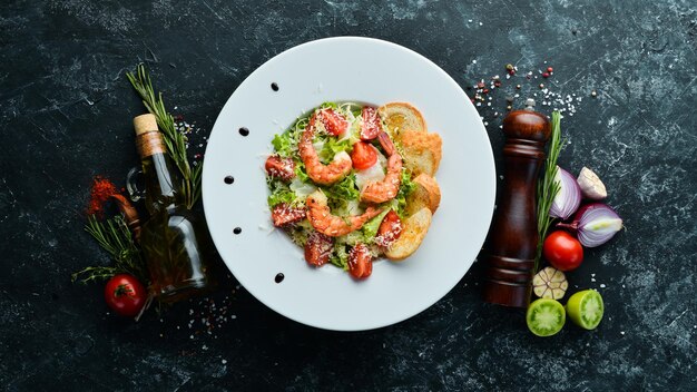 Vegetable salad with shrimp and cherry tomatoes Caesar salad with prawns Top view Free space for your text